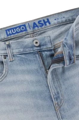 Jeans slim fit de denim azul lavado a la piedra