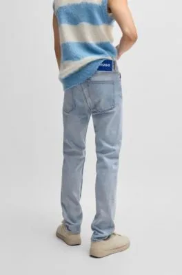 Jeans slim fit de denim azul lavado a la piedra