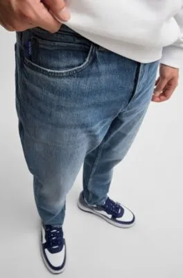 Jeans tapered fit de denim azul lavado a la piedra